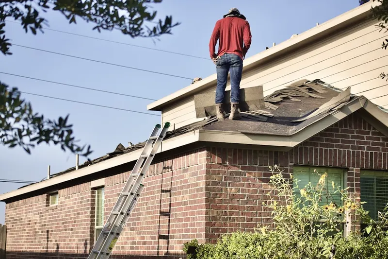 Professional roofer working on a residential roof in Eagles